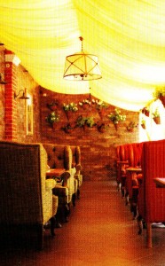 Cheap interior of summer cafe. Nothing more. Controversial element in the interior are the flowers on the wall.