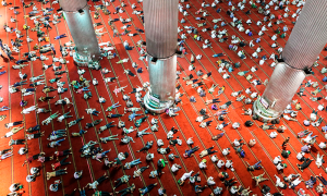 Indonesian Muslims lay down on the floor as others read the Koran shortly after the Friday prayers on the holy month of Ramadan at Istiqlal mosque