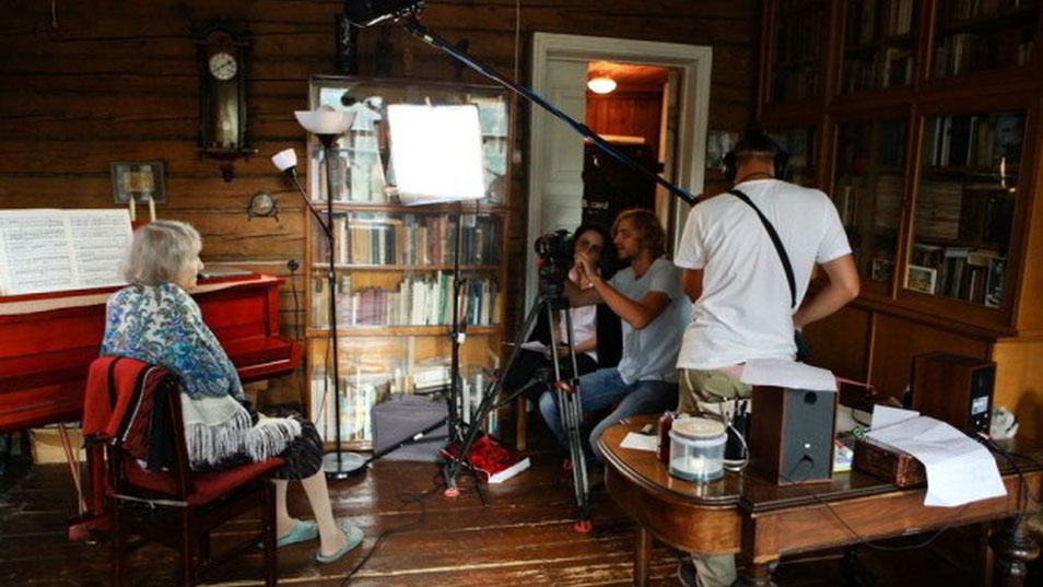 Getting history on film: interviewing one of the camp survivors.