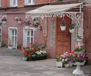 pots and pots of blooming flowers at the entrance