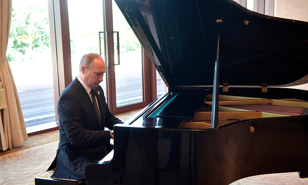 Putin plays two songs about Moscow and St. Petersburg during China visit