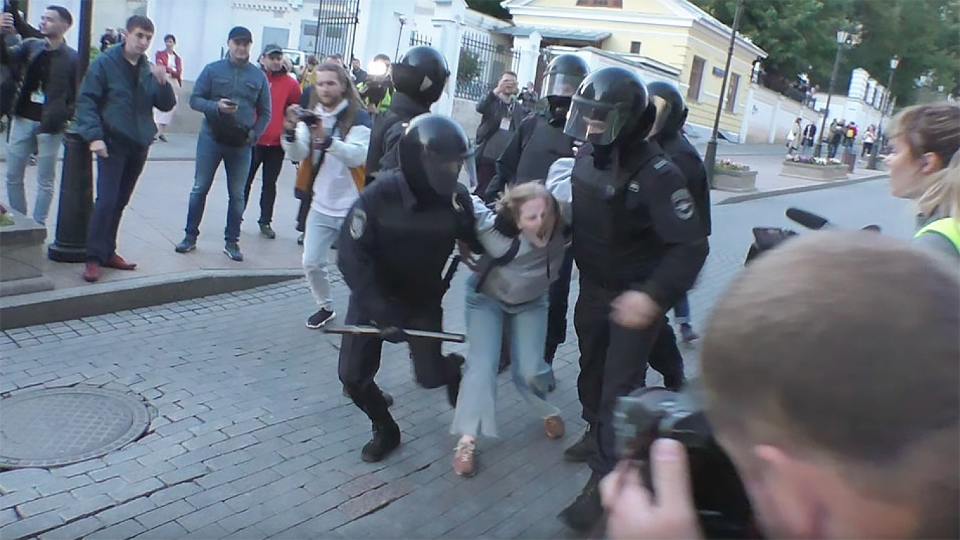 Viral Clip of Russian Policeman Punching Young Woman During Protests Stirs Anger