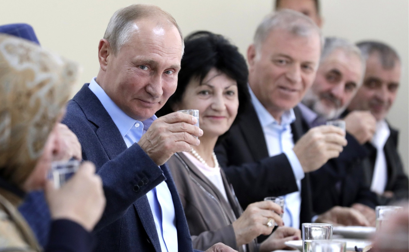 Putin Drinks Vodka to Russian Soldiers in North Caucasus