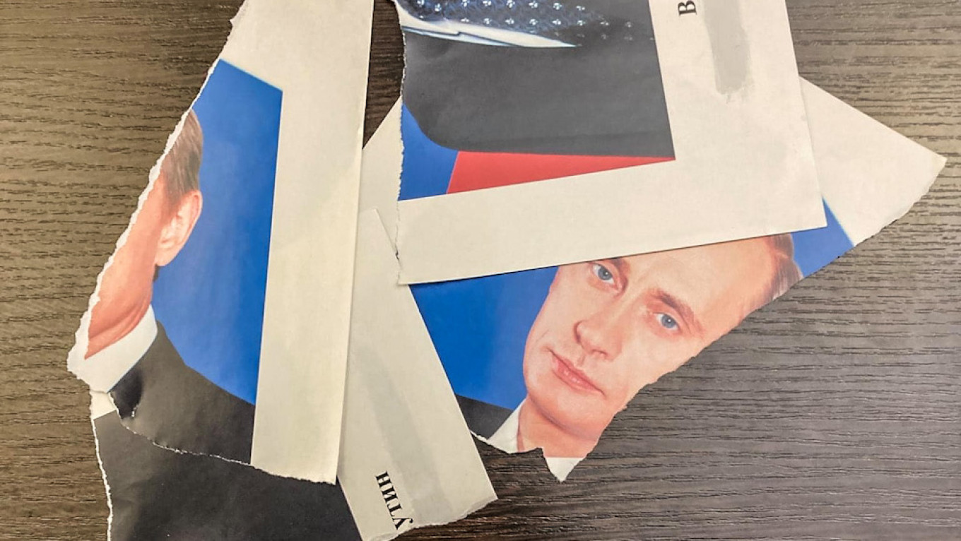 St. Petersburg Opposition Official Questioned By Police After Ripping Putin Portrait
