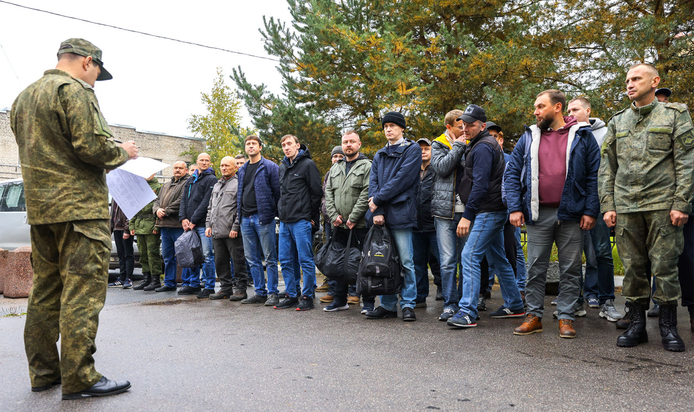  Mobilized men line up outside a military recruitment office in St Petersburg. Peter Kovalev / TASS 