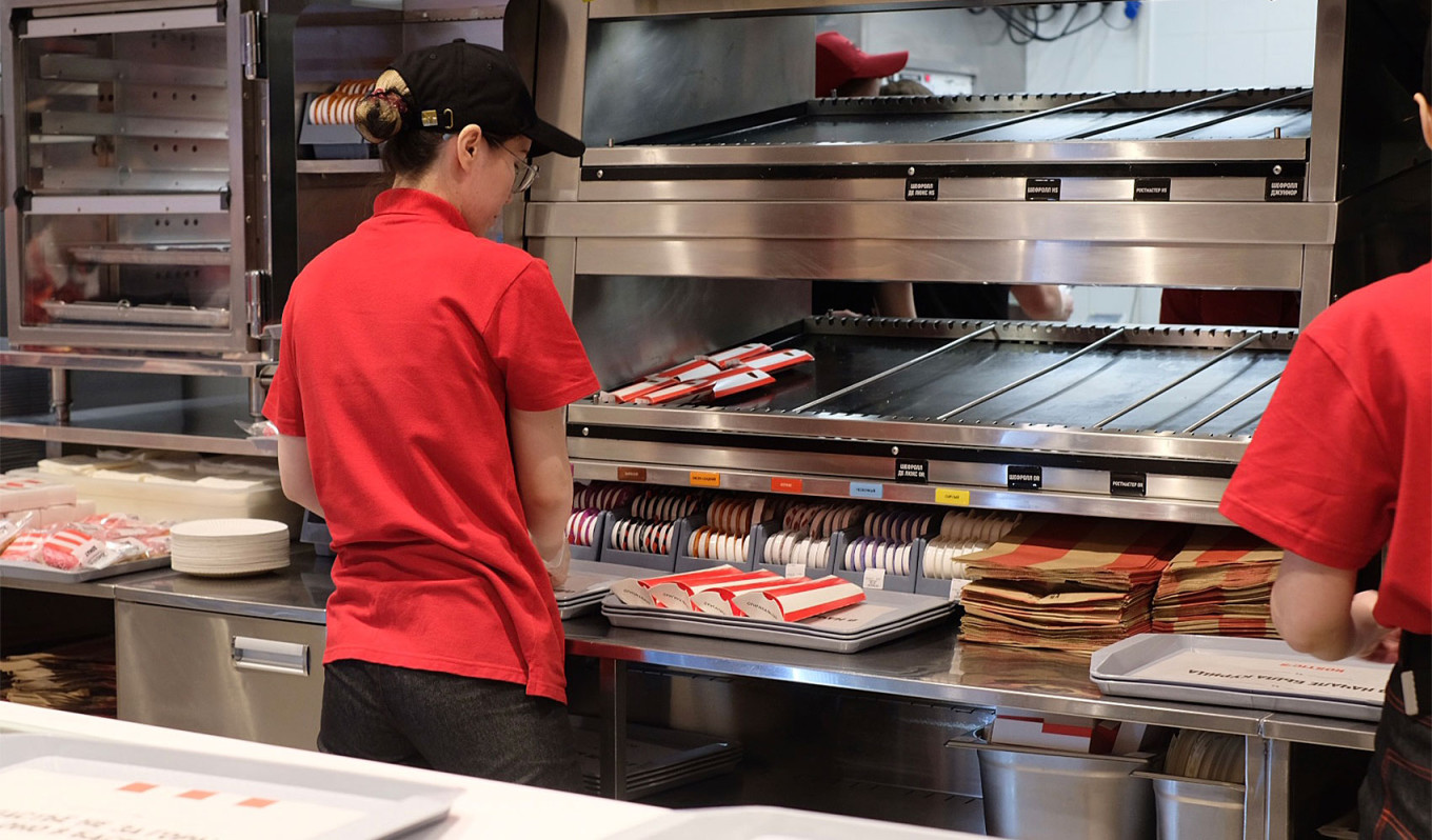  An employee preparing food at the rebranded Rostic's, which uses the same equipment as the former KFC restaurant. MT 