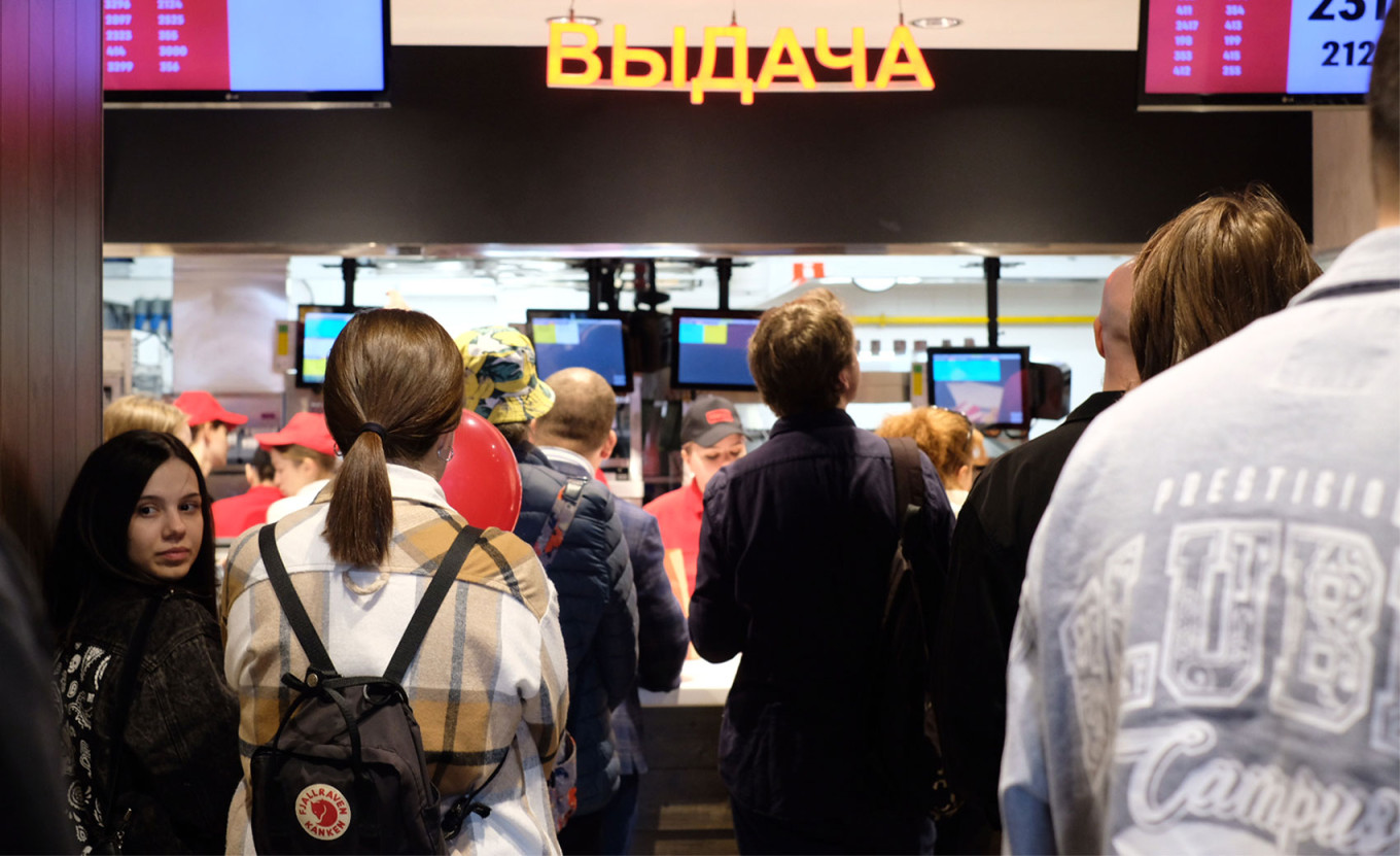  Customers wait for their orders at the pick-up counter. MT 