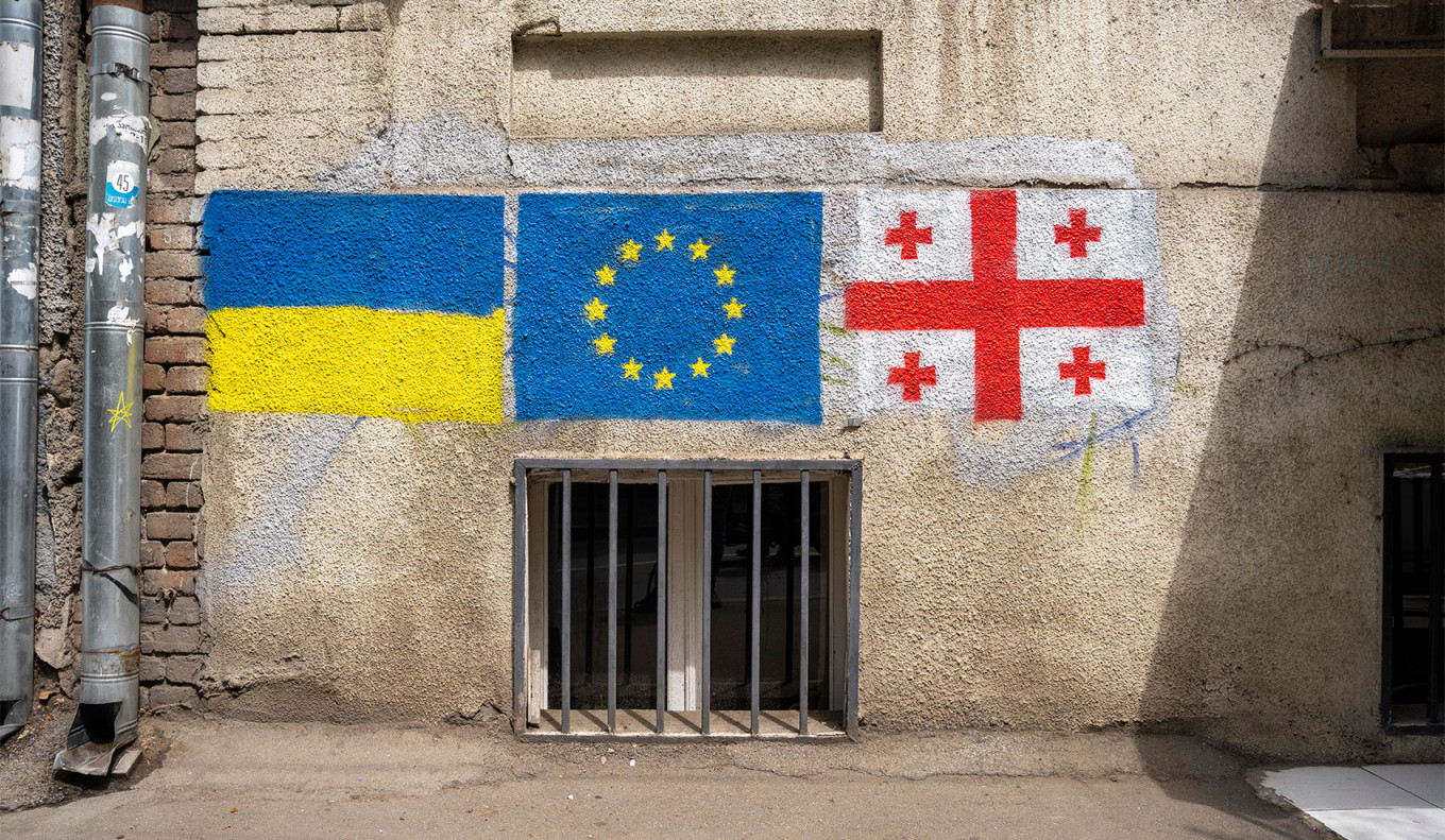  Street art in Tbilisi shows the Ukrainian, European and Georgian flags side by side. Antoine Boureau / Hans Lucas via Reuters Connect 