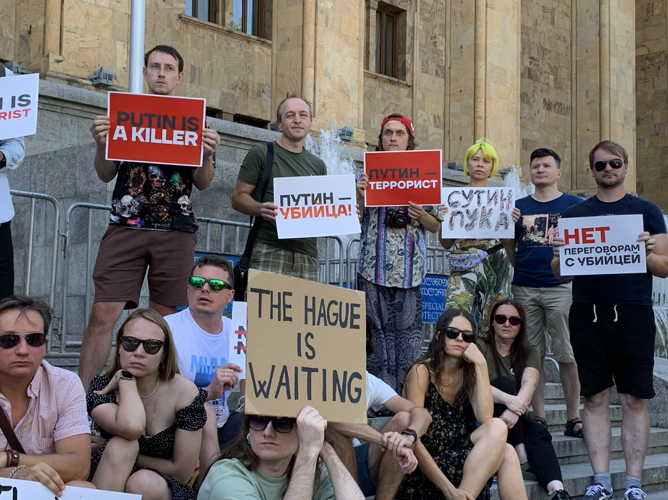  Protesters in front of Georgia’s parliament building holding signs that read “Putin is a terrorist” and “Say ‘no’ to negotiating with killers.” Mack Tubridy / MT 