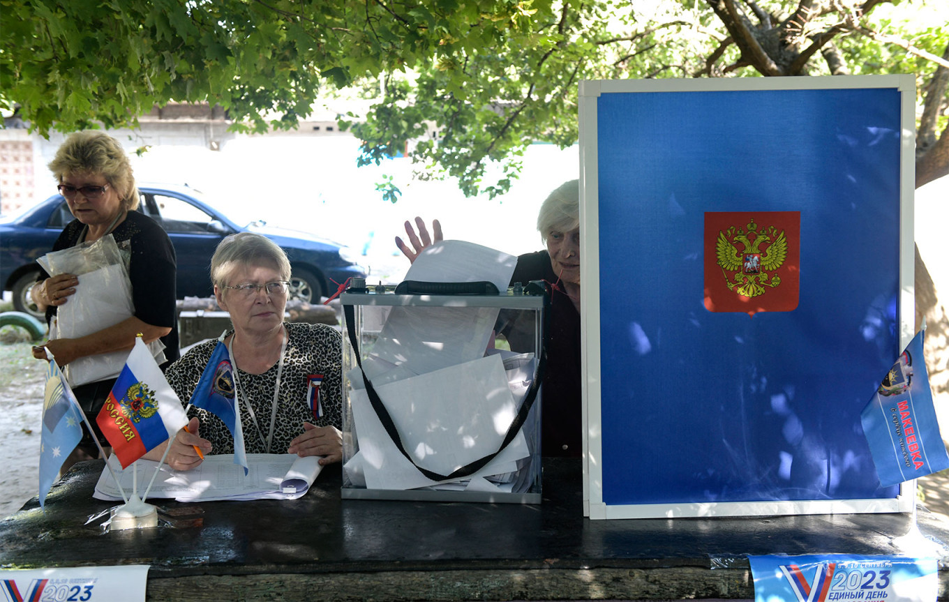  A woman casts her ballot at a mobile polling station during early voting for local elections organized by the Russian-installed authorities in the occupied city of Donetsk in eastern Ukraine. AFP 