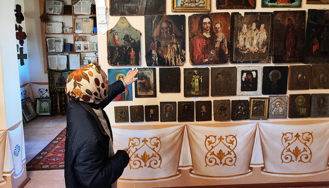  Liubov Alekseevna shows a collection of icons in the sanctuary. MT 