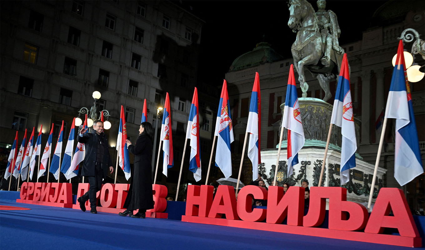  The leader of the People's Movement of Serbia Miroslav Aleksic (L) greets Party of Freedom and Justice's Marinika Tepic (R) during the final pre-election rally of the Serbia Against Violence opposition coalition in Belgrade. Andrej Isakovic / AFP 