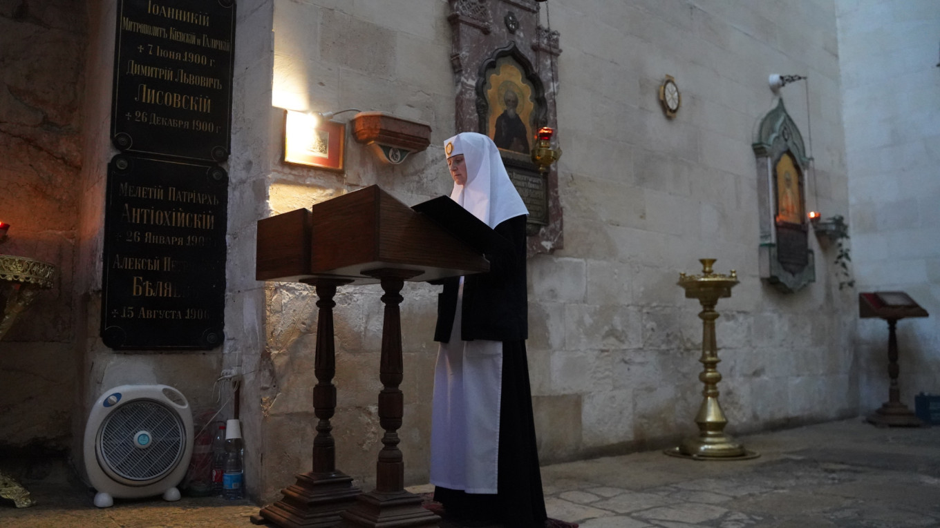  Sister Ioanna praying in front of the Threshold of the Judgement Gate in Jerusalem. Iryna Matviyishyn 