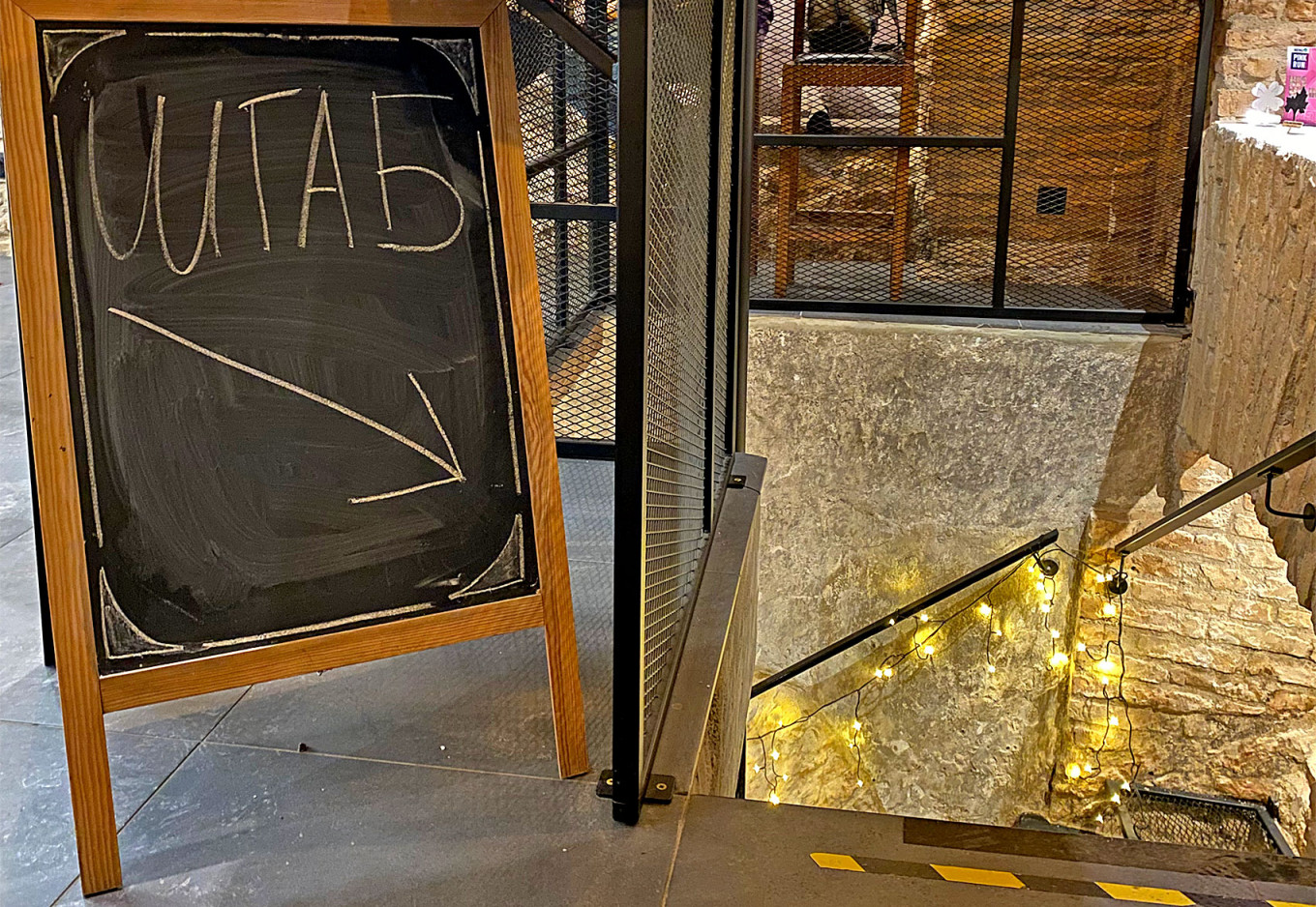  A sign pointing to the basement of Not Only Coffee reads "headquarters." Lukas Žalalis 