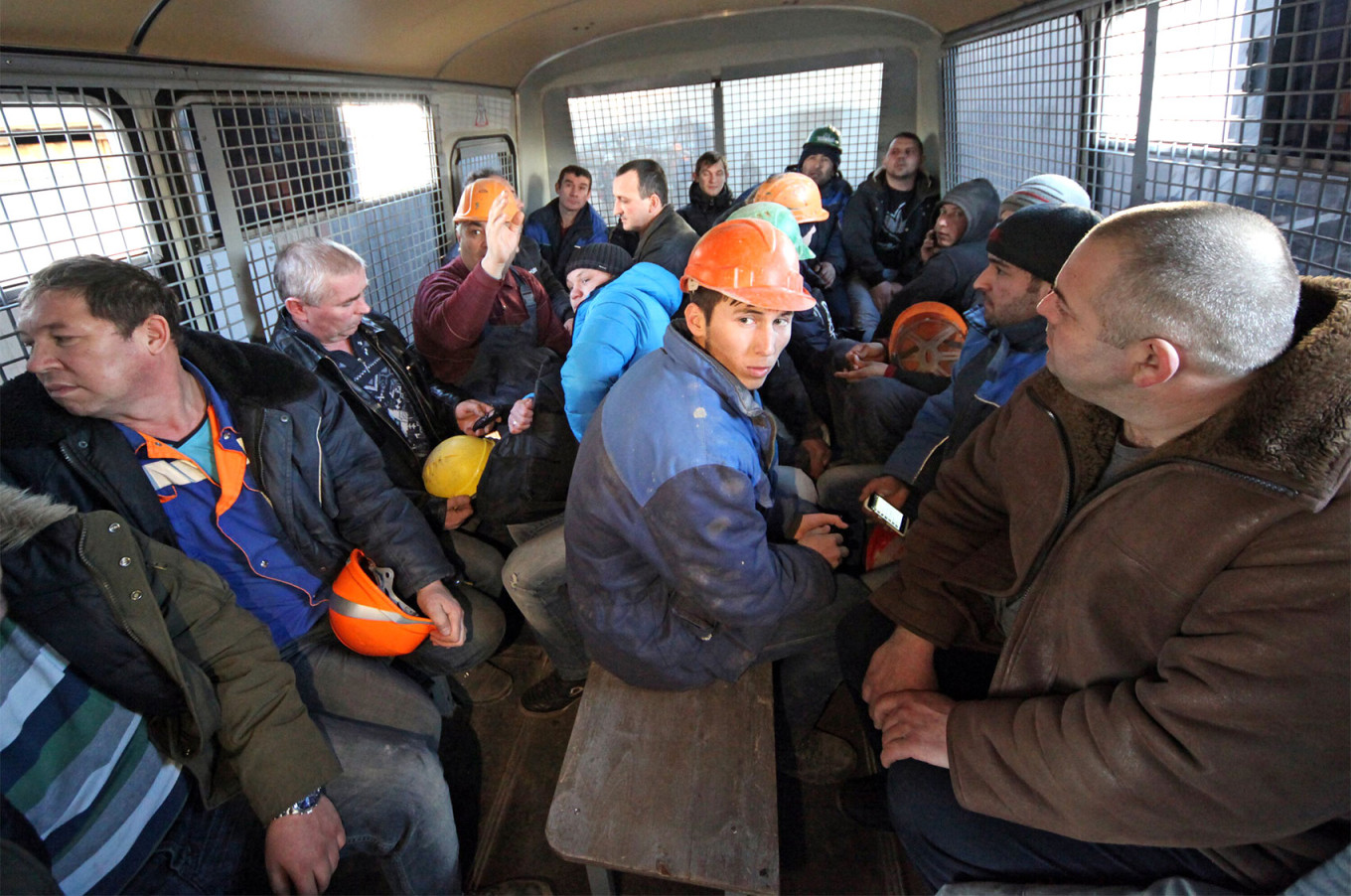  Workers at a construction site in Moscow who were detained following a police raid. Moskva News Agency 