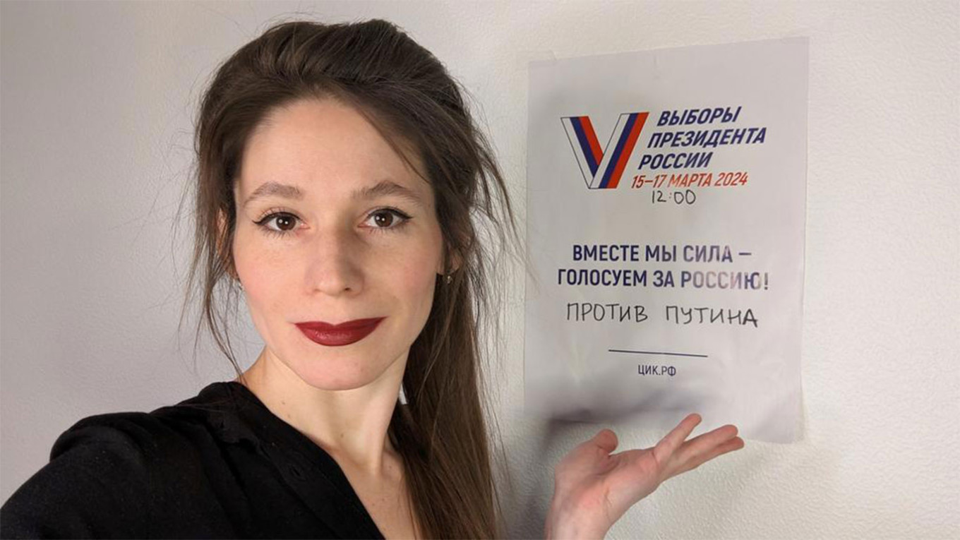  In a selfie, Favorskaya stands in front of a sign promoting the opposition's Noon Against Putin protest on the final day of voting in the presidential election. @AntigonaFreeman / X 